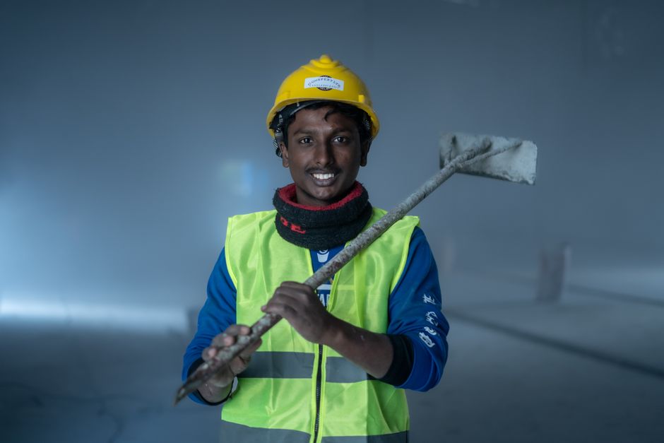 Friendly construction worker discussing home insulation options